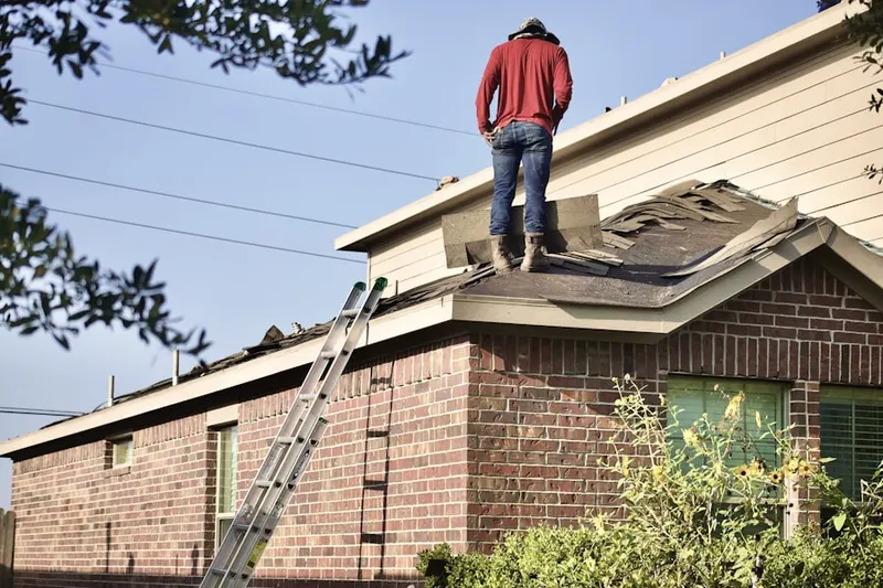 Professional roofer working on a residential roof in Atlantic Beach